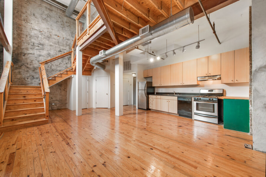 kitchen and living area and a stairway in a loft apartment